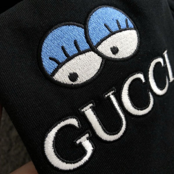 Gucci Floral neckline embroidered polo shirt with cartoon lettering